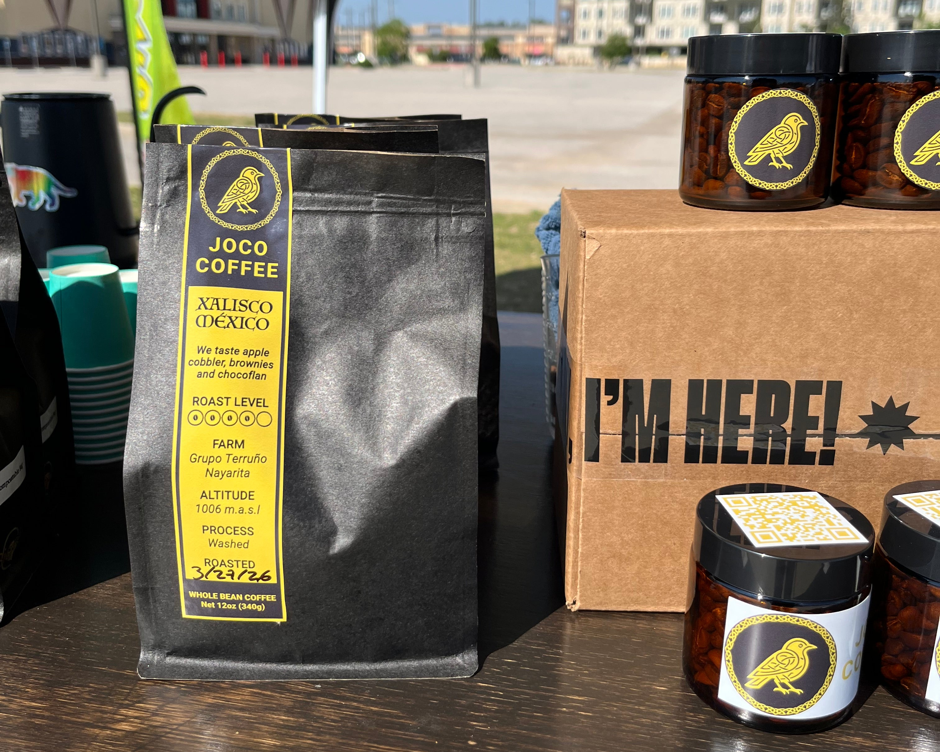 JOCO Coffee bags with visible branding on a wooden surface outdoors