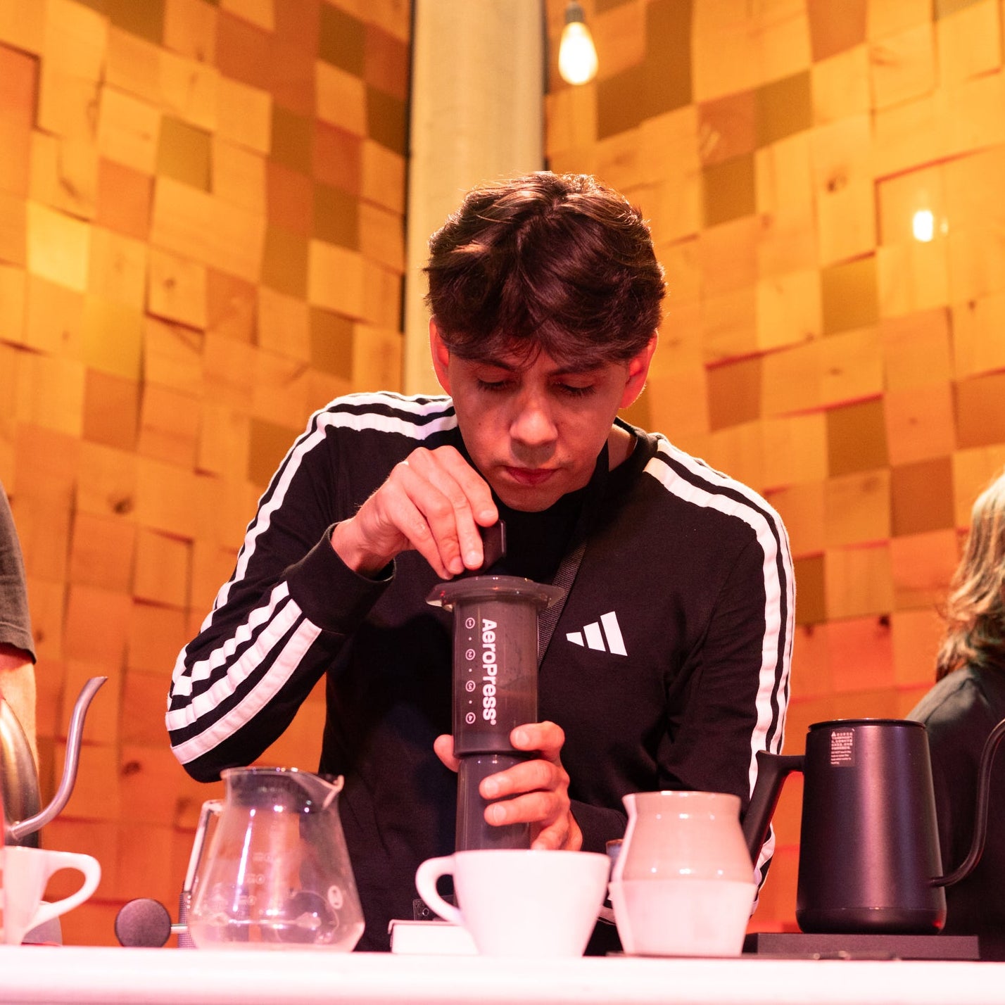 co-owner of JOCO coffee preparing a coffee drink at a coffee competition during the 2025 Austin aeropress championship 